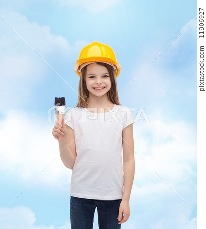 smiling little girl in helmet with paint roller smiling little girl in helmet with paint roller 11906927