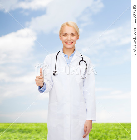 smiling female doctor showing thumbs up 11907395