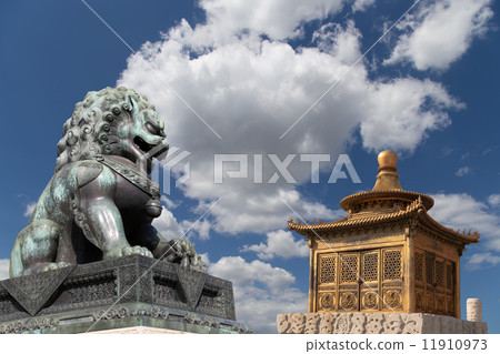 Bronze Guardian Lion Statue and bronze pagoda in the Forbidden City, Beijing, China Bronze Guardian Lion Statue and bronze pagoda in the Forbidden City, Beijing, China 11910973