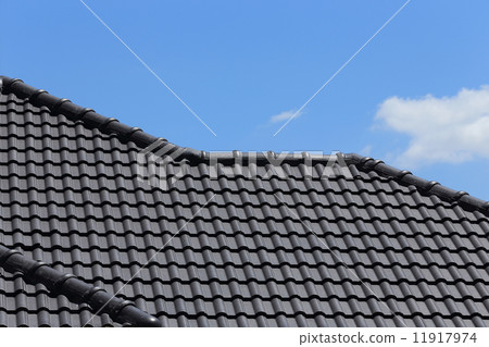 black tiles roof on a new house with blue sky 11917974