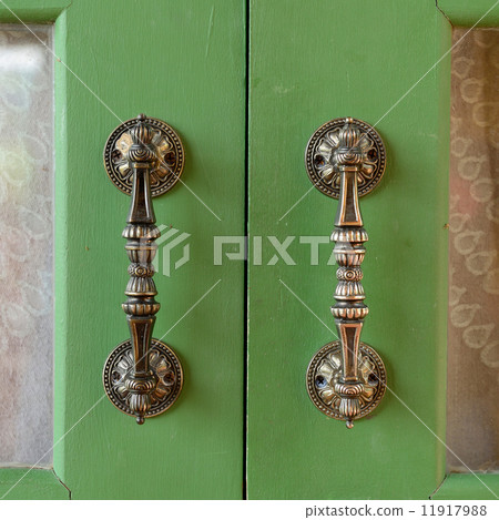 Door handle on green wooden door 11917988