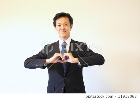 A businessman posing with a heart mark A businessman posing with a heart mark 11918068
