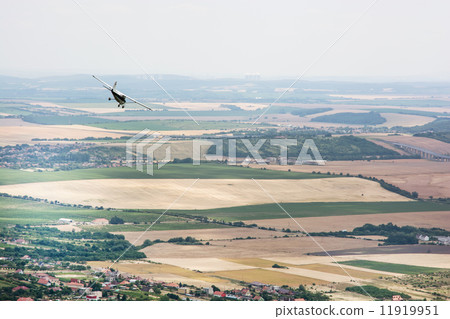 Small plane flies over the large country Small plane flies over the large country 11919951