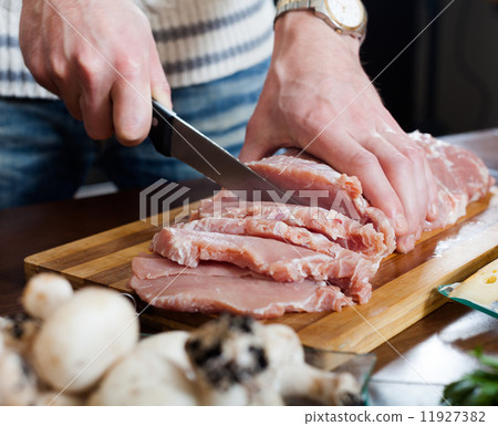 Hands cutting meat Hands cutting meat 11927382