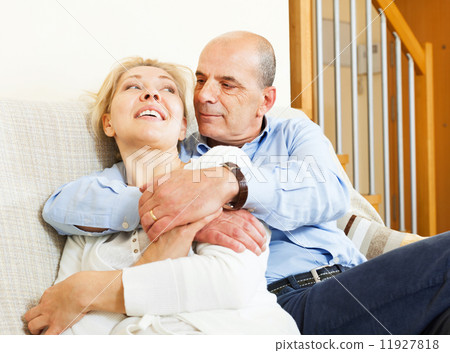 mature couple on sofa in home interior 11927818
