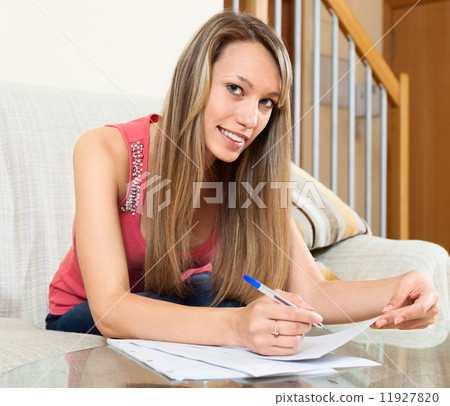 woman editing documents at table woman editing documents at table 11927820