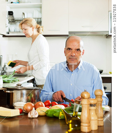 mature man helping his wife in household work mature man helping his wife in household work 11927838