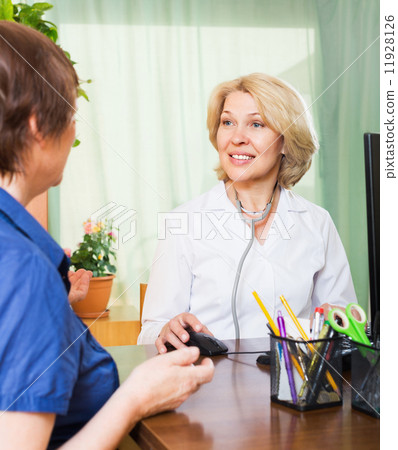Positive doctor consulting female patient Positive doctor consulting female patient 11928126