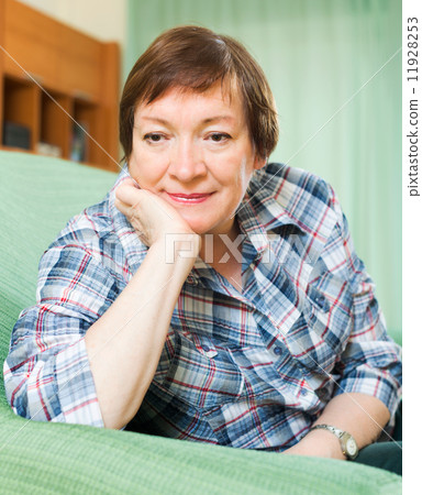 Stressed female pensioner on couch 11928253