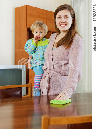 Woman cleaning wooden furiture with rag at home Woman cleaning wooden furiture with rag at home 11928258