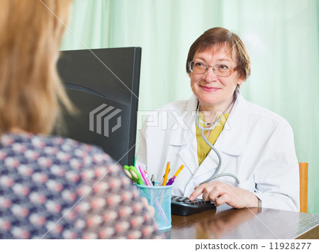Doctor inserting information about patient 11928277