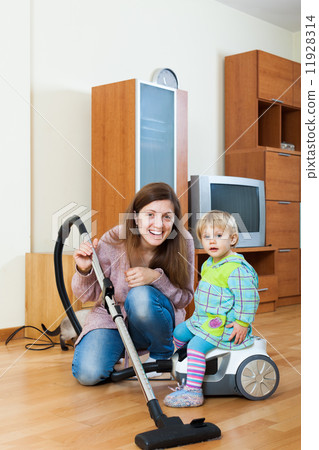 Mother with baby cleaning home Mother with baby cleaning home 11928314