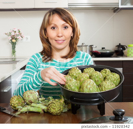 woman cooking artichokes woman cooking artichokes 11928342