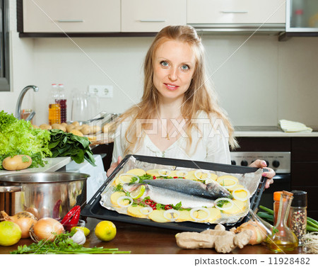 Ordinary woman cooking fish and potato in sheet pan 11928482