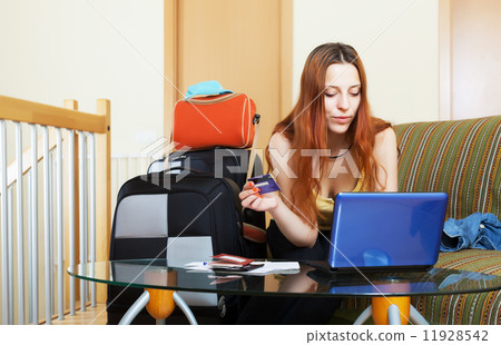 Woman reserving resort online in the internet Woman reserving resort online in the internet 11928542