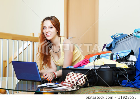 Young woman reserving hotel on the internet Young woman reserving hotel on the internet 11928553