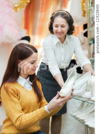 women chooses white shoes at shop women chooses white shoes at shop 11928600