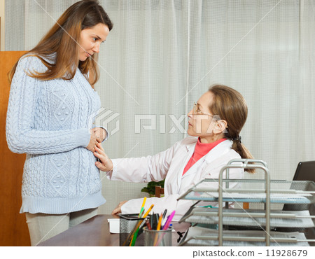 Doctor with young female patient 11928679