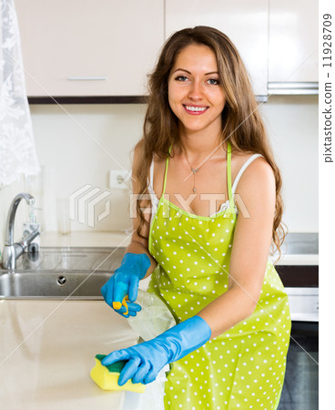 Happy woman cleaning kitchen Happy woman cleaning kitchen 11928709