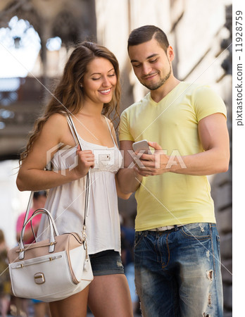 Couple using the map at smartphone 11928759