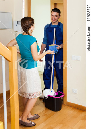 Woman meeting cleaner at door 11928771