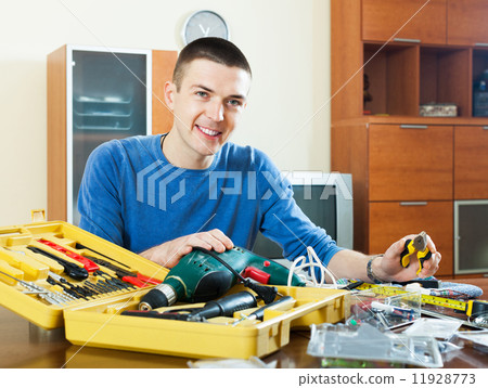 Happy smiling man organizing toolbox 11928773