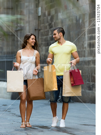 smiling loving couple with shopping bags at city 11928784