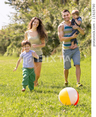 Parents with two children in the park Parents with two children in the park 11928790