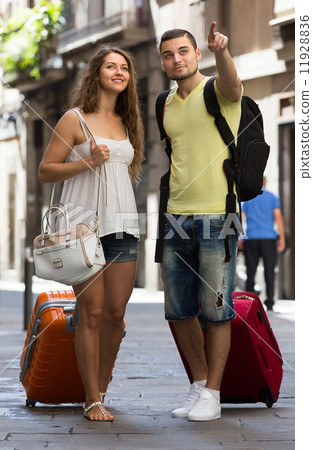 Travelers with baggage in the street 11928836