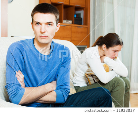 Unhappy guy against angry woman at home Unhappy guy against angry woman at home 11928837