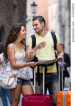 Couple with luggage reading map Couple with luggage reading map 11928939