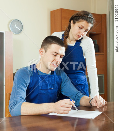 Workers in uniform with documents 11928942