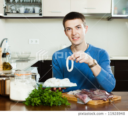 guy cooking in home kitchen 11928948