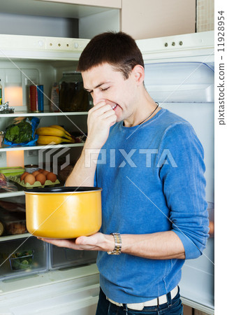 man holding her nose because of bad smell from food 11928954