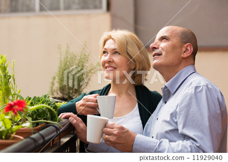 Aged couple drink tea on balcony Aged couple drink tea on balcony 11929040