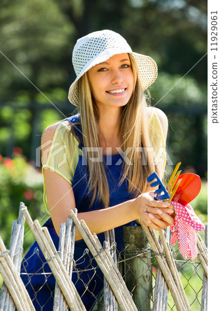 Happy woman in uniform at yard gardening 11929061