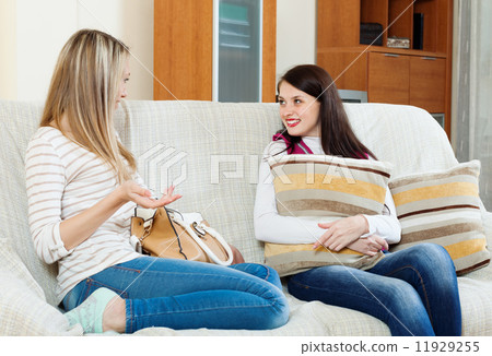 Two casual women gossiping on sofa Two casual women gossiping on sofa 11929255