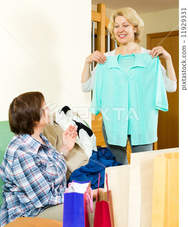 Two women checking purchases 11929331