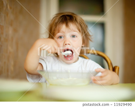 child eats dairy with spoon 11929490