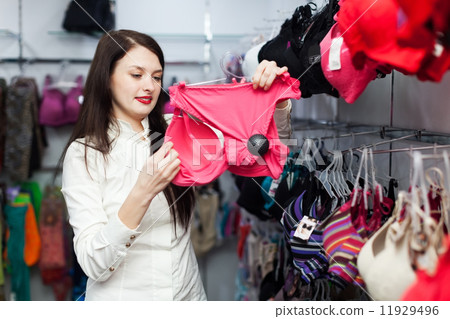 Smiling woman choosing bra at store Smiling woman choosing bra at store 11929496