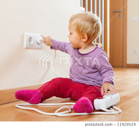 Toddler playing with extension cord and outlet 11929529