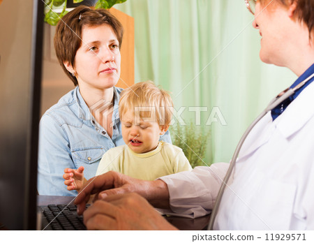 woman with baby listening doctor at clinic 11929571