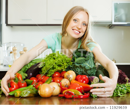 happy woman with pile of vegetables 11929639