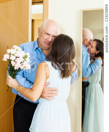 Senior man came to woman with flowers 11929869