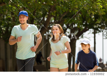 Happy family with child running in park 11930002
