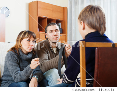 Parents with belt berating son 11930013