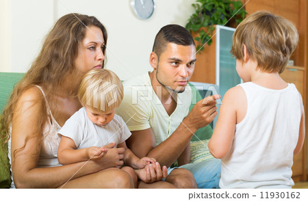Parents scolding child in home 11930162