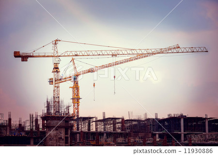 Construction site with cranes on sky background, retro tone imag 11930886