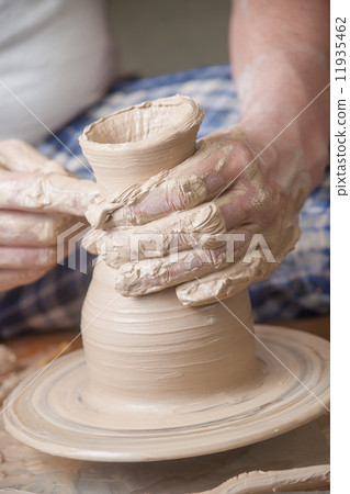 Hands of a potter 11935462