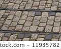 old tram rails on cobblestone 11935782